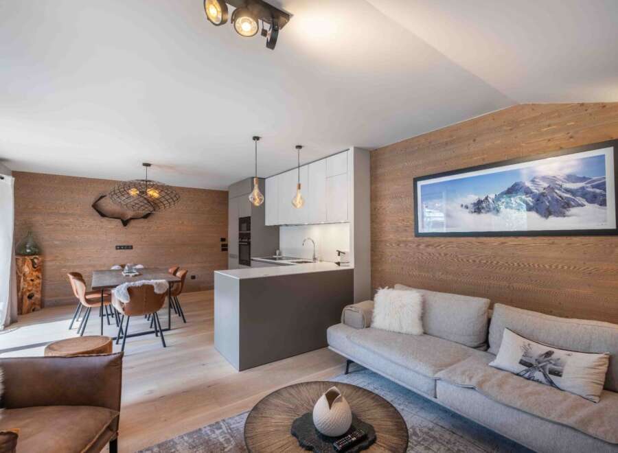 Experience luxury living in this stunning property, featuring a modern kitchen and a cozy living area.