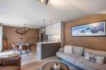 Experience luxury living in this stunning property, featuring a modern kitchen and a cozy living area.