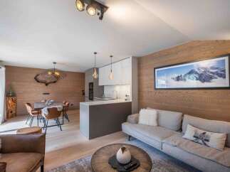 Experience luxury living in this stunning property, featuring a modern kitchen and a cozy living area.