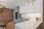 This modern kitchen boasts sleek cabinetry and a pristine countertop, perfect for culinary enthusiasts.
