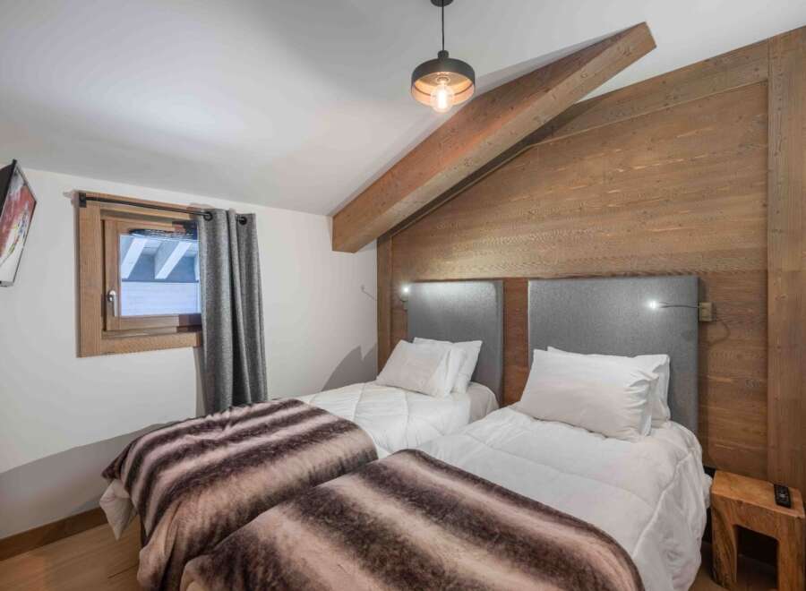 This cozy bedroom features two twin beds, perfect for guests or a shared living space.