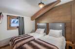 This cozy bedroom features two twin beds, perfect for guests or a shared living space.