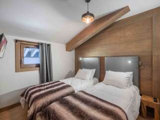 This cozy bedroom features two twin beds, perfect for guests or a shared living space.