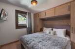 Experience the ultimate comfort in this cozy bedroom, featuring a plush bed and a stunning view.