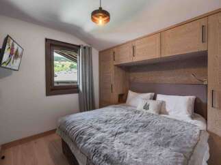 Experience the ultimate comfort in this cozy bedroom, featuring a plush bed and a stunning view.