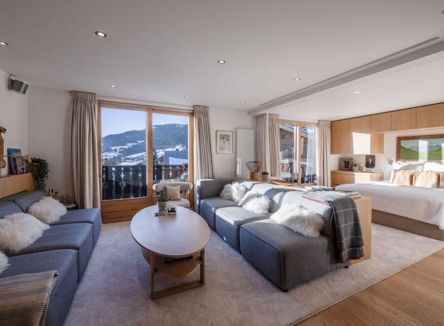 Experience luxury living in this stunning property, featuring a spacious living area with a cozy sofa and a beautiful view.