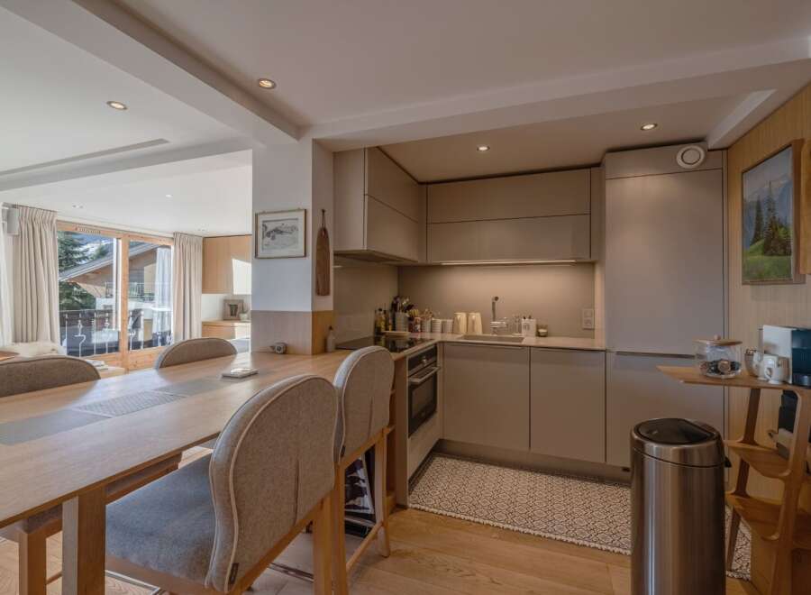This stunning property boasts a modern kitchen with sleek cabinetry and stainless steel appliances, perfect for culinary enthusiasts.