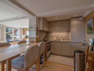 This stunning property boasts a modern kitchen with sleek cabinetry and stainless steel appliances, perfect for culinary enthusiasts.