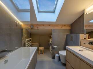 This modern bathroom boasts a unique design with a skylight that floods the space with natural light.