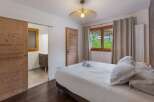 Discover the charm of this inviting bedroom, featuring a cozy bed and a stylish design.