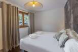 This cozy bedroom offers a serene retreat with its inviting ambiance and stylish design.