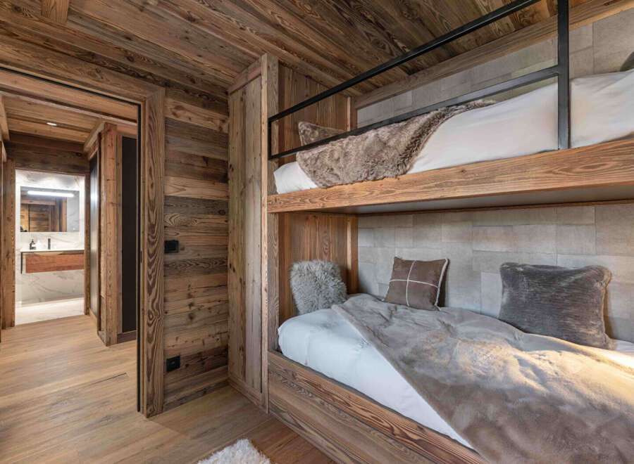 This stunning property features a cozy bedroom with custom-built bunk beds, perfect for accommodating guests or family.