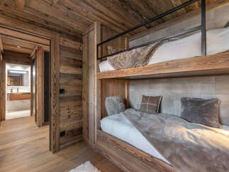 This stunning property features a cozy bedroom with custom-built bunk beds, perfect for accommodating guests or family.