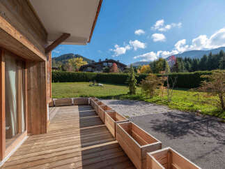 Enjoy the tranquility of this stunning property, featuring a beautifully crafted wooden deck perfect for outdoor relaxation.