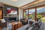 Experience luxury living in this stunning property, featuring a cozy living room with a fireplace and a large TV perfect for entertainment.