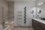 Step into this modern bathroom, featuring a sleek design and neutral color palette.