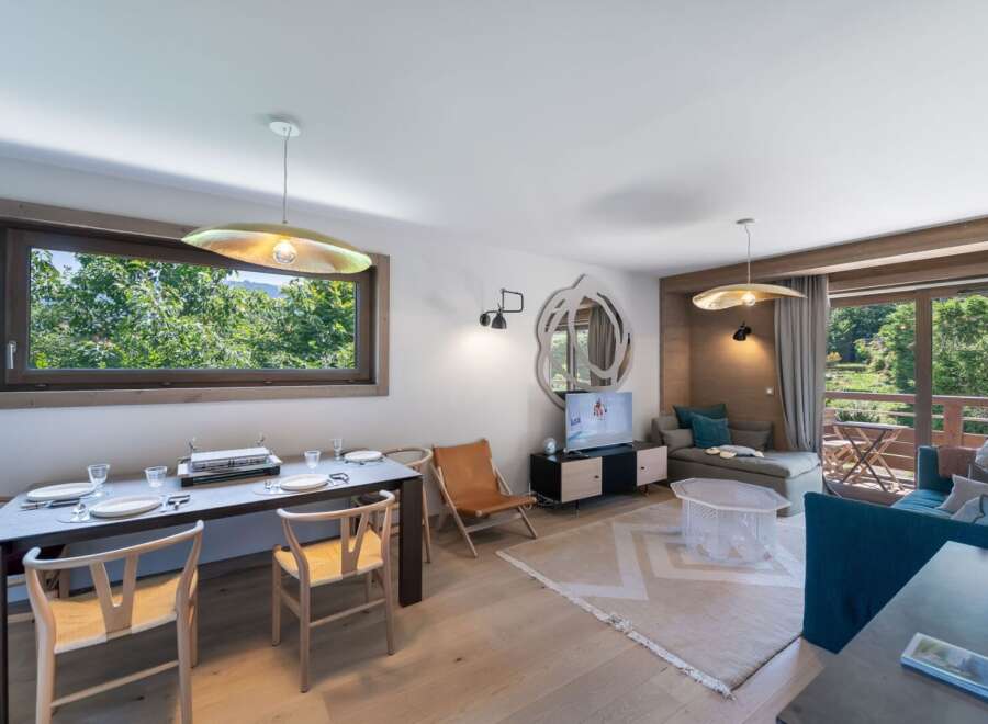 Experience luxury living in this stunning property, featuring a modern dining area with elegant chairs and a sleek table.