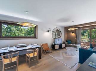 Experience luxury living in this stunning property, featuring a modern dining area with elegant chairs and a sleek table.