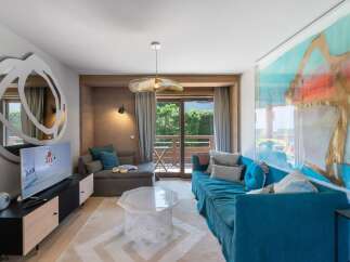 Experience luxury living in this stunning property, featuring a beautifully designed living room with a modern aesthetic.