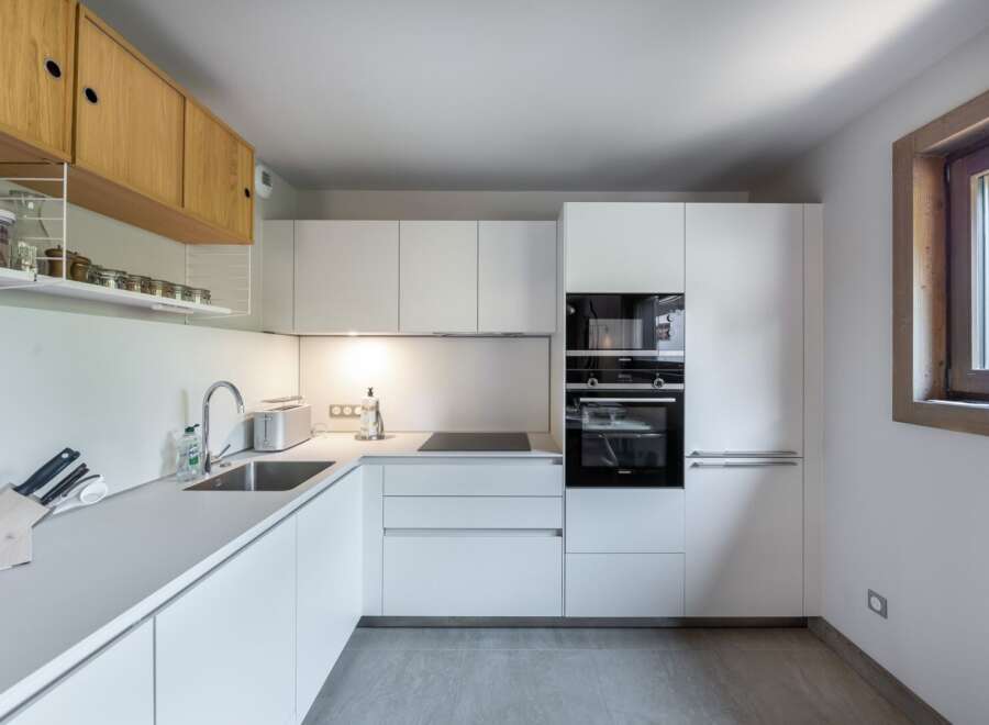 This modern kitchen boasts sleek, minimalist design with clean lines and ample storage.
