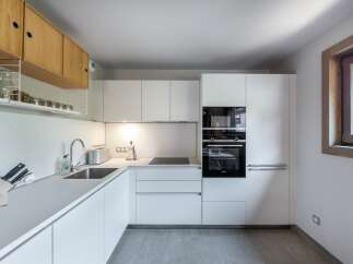 This modern kitchen boasts sleek, minimalist design with clean lines and ample storage.
