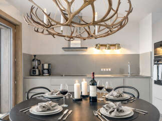 Experience luxury living in this stunning property featuring a modern kitchen and elegant dining area.