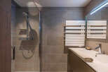 Step into a modern bathroom oasis! This stylish space features a sleek shower with a glass enclosure, perfect for a refreshing start to your day.