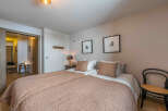 This cozy bedroom offers a warm and inviting atmosphere, perfect for relaxation.