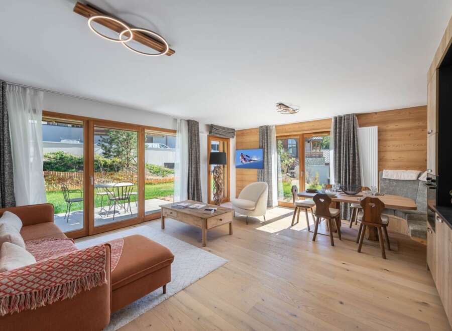 Experience luxury living in this stunning property, featuring a spacious living area with a cozy sofa and a dining area perfect for entertaining.
