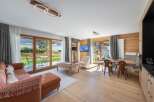 Experience luxury living in this stunning property, featuring a spacious living area with a cozy sofa and a dining area perfect for entertaining.