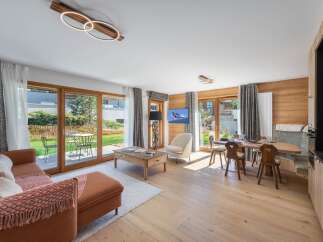 Experience luxury living in this stunning property, featuring a spacious living area with a cozy sofa and a dining area perfect for entertaining.