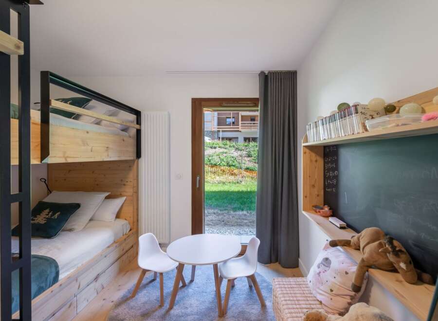 This charming children's bedroom features a cozy bunk bed, perfect for siblings or sleepovers.