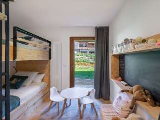 This charming children's bedroom features a cozy bunk bed, perfect for siblings or sleepovers.