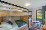 This charming bedroom features a unique bunk bed design, perfect for maximizing space.