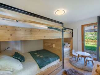This charming bedroom features a unique bunk bed design, perfect for maximizing space.
