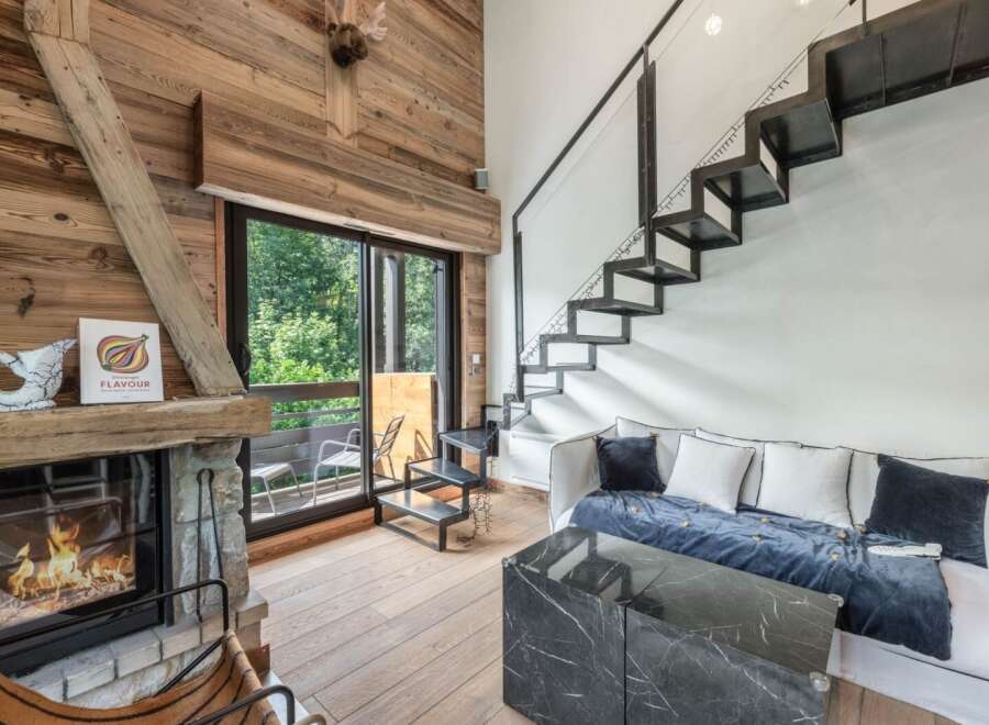 This stunning property boasts a cozy living room with a fireplace, perfect for relaxing evenings.