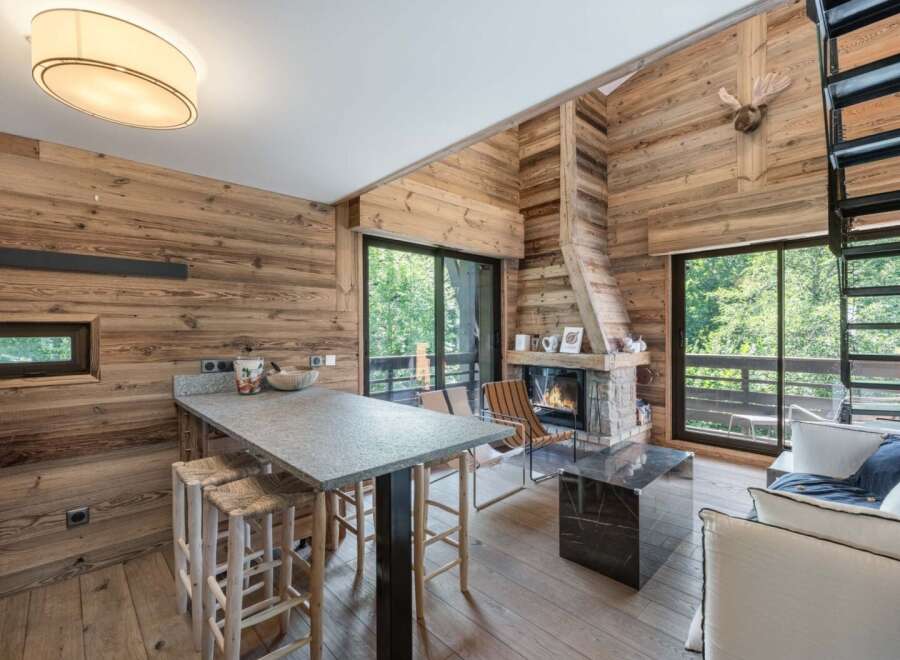 Experience rustic elegance in this stunning property, featuring a cozy fireplace and beautiful wooden accents throughout.