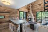 Experience rustic elegance in this stunning property, featuring a cozy fireplace and beautiful wooden accents throughout.