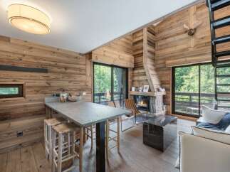 Experience rustic elegance in this stunning property, featuring a cozy fireplace and beautiful wooden accents throughout.