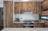 This stunning kitchen boasts a rustic charm with its beautiful wooden cabinetry and countertops.