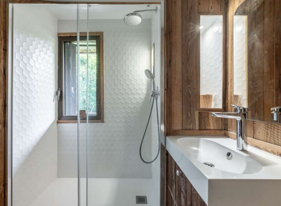 This stunning bathroom features a modern design with a touch of rustic charm.