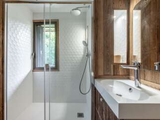 This stunning bathroom features a modern design with a touch of rustic charm.