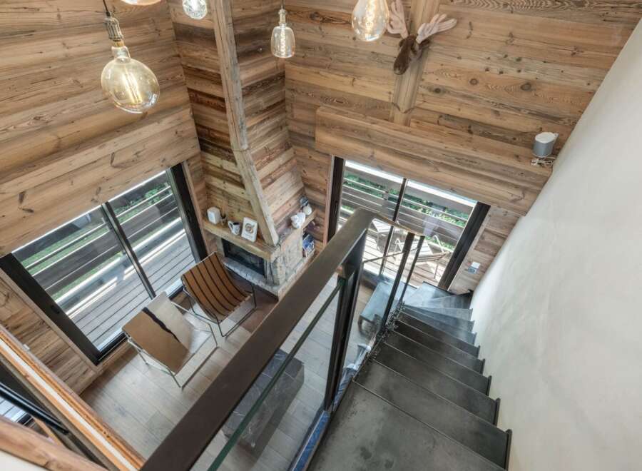 This stunning property boasts a rustic charm with its wooden interior and cozy fireplace.