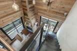 This stunning property boasts a rustic charm with its wooden interior and cozy fireplace.