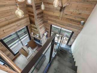 This stunning property boasts a rustic charm with its wooden interior and cozy fireplace.