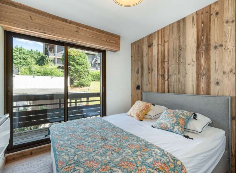 Discover the charm of this inviting bedroom, featuring a stunning wooden accent wall that adds warmth and character.