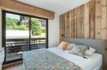 Discover the charm of this inviting bedroom, featuring a stunning wooden accent wall that adds warmth and character.