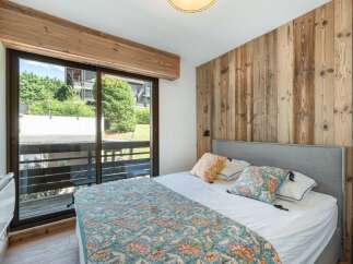 Discover the charm of this inviting bedroom, featuring a stunning wooden accent wall that adds warmth and character.