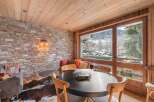 Experience the charm of this stunning property, featuring a cozy dining area with a round table and comfortable chairs.