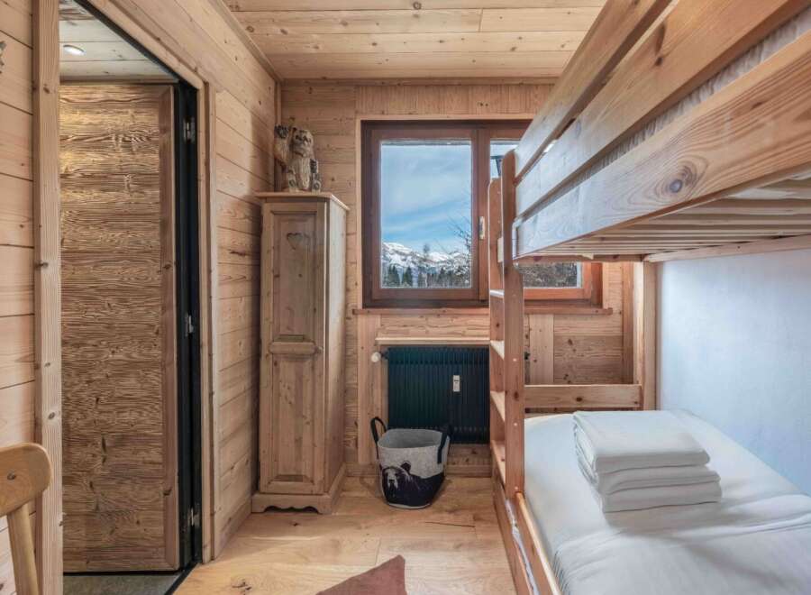Step into this cozy mountain retreat, featuring a charming bunk bed perfect for family or guests.